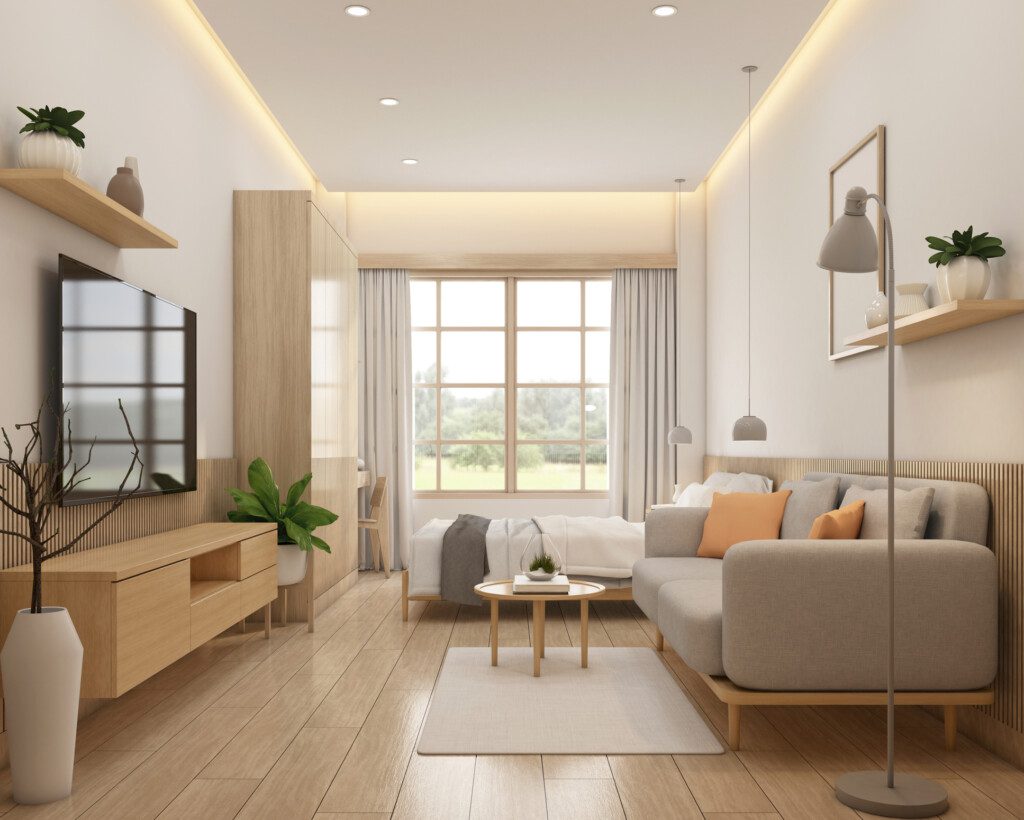 Imagem de um ambiente minimalista com sofá, mesa de centro, tapete, raque, televisão e alguns itens decorativos para ilustrar matéria sobre apartamento para solteiro