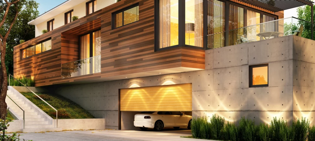 Imagem de uma casa moderna com uma garagem abaixo do nível da rua para ilustrar matéria sobre garagem subterrânea: vantagens e desvantagens